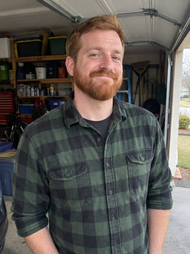 Uploaded photo: A garage snapshot in flannel. Same ginger beard and smug grin, patting the horse like it was a steal.
