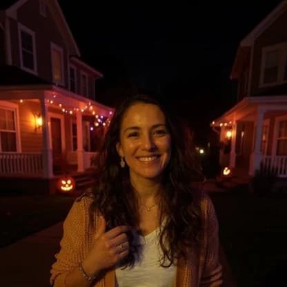 A woman on a night street with glowing porches, an AI trick-or-treat Halloween photo