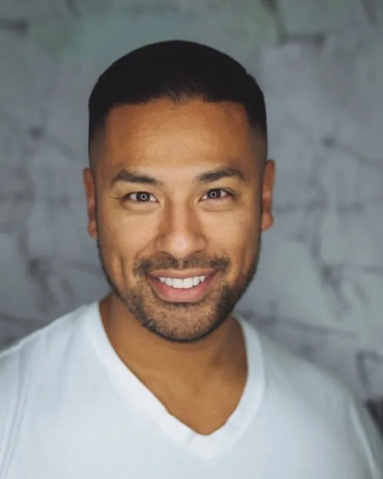 The same man with an AI-preview skin fade, short top and sides fading to skin