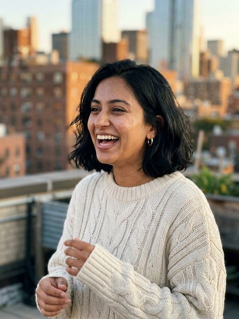 Uploaded photo: A rooftop photo at golden hour. Same bob and big laugh, now hosting the chandelier dinner.